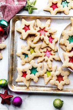 christmas cookies on a tray with ornaments around them