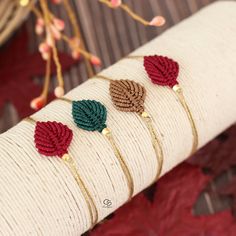 four bracelets with crocheted leaves on them