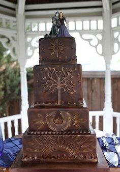 a three tiered cake with figurines on top