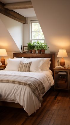 a bed sitting under a window next to two lamps