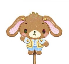 a brown and white stuffed animal standing on top of a wooden stick in front of a white background