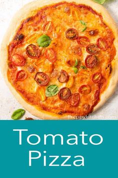 a pizza sitting on top of a table next to a green leafy plant and the words tomato pizza