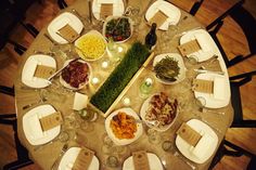 the table is set with many dishes and place settings for people to enjoy their meal