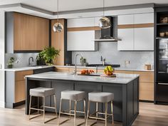 a kitchen with an island and stools in it