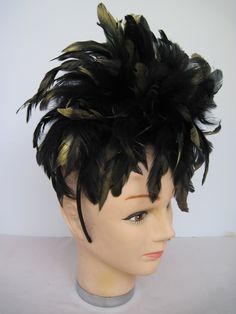 "* This fascinator features coal black 6-7\" feathers all tipped in gold. Perfect for fall and winter and with the spider fantastic for Halloween or a costume party. If desired, you can remove the spider. * A generous supply of feathers create a feminine look and allows any slight breeze to create a flutter adding motion and sophistication to the design. * On a black satin covered acrylic headband the design is secure, evenly balanced and on trend with the gold tipping. Try it on front to back a Black Feathered Headpiece For Costume, Black Ostrich Feather Headpiece, Black Feathered Headband Fascinator, Black Ostrich Feather Trim Headpiece, Black Feathered Headband For Party, Black Feather Headband For Parties, Feathered Hats And Headpieces For Halloween Costume Party, Black Feathered Party Headband, Black Feather Trim Costume Hats For Party