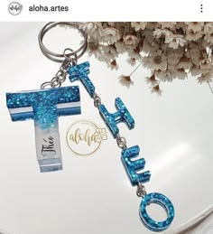 a blue cross keychain with the word hope on it and a name tag attached to it