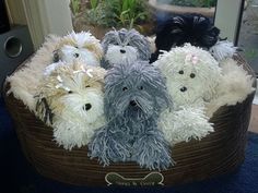 several stuffed dogs are sitting in a basket