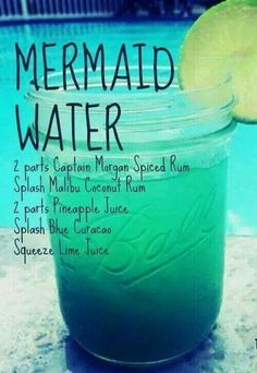 a jar filled with green liquid next to a swimming pool and the words mermaid water on it