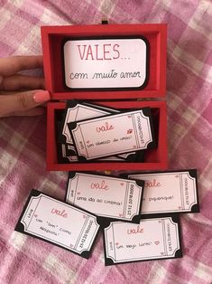 four red boxes with black and white labels in them on a pink checkered tablecloth