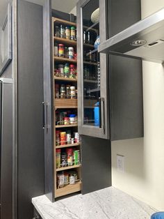 an open pantry in the corner of a kitchen