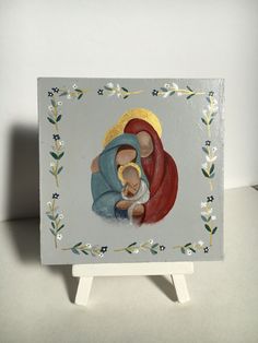 an image of the virgin mary and child jesus on a white background with blue flowers