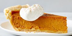 a slice of pumpkin pie with whipped cream on top