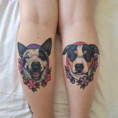 two dogs with flowers on their legs sitting next to each other