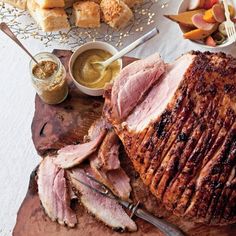 the ham is sliced up and ready to be served on the table with other foods