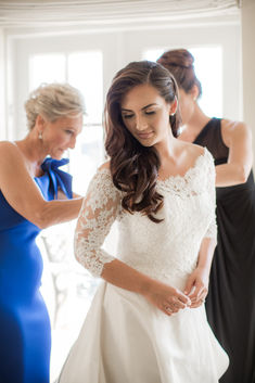 the bride is getting ready for her big day with her mother and grandmother in the background