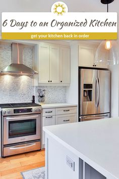 a white kitchen with stainless steel appliances and an island in front of the stove top