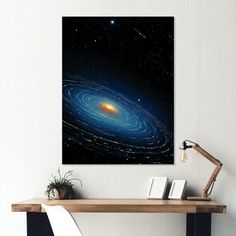 a table with a book and some books on it in front of a space poster