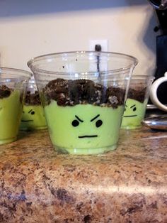 three cups with plants in them sitting on a counter