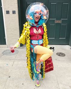 a woman dressed as a clown holding a bubble