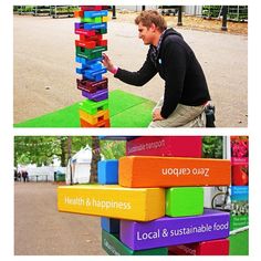 a man is playing with colorful blocks in the middle of an open area and on top of it