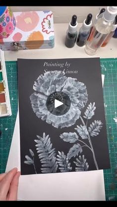 someone is making a card with an image of a flower