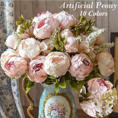 a vase filled with pink flowers on top of a table