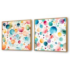 two colorful paintings hanging on the wall next to each other, one with balloons painted on it