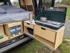 an open camper van with the bed pulled out