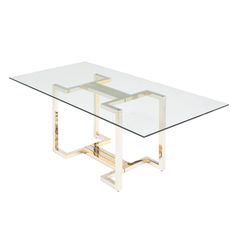 a glass table with two metal legs and a square shaped design on the top, against a white background