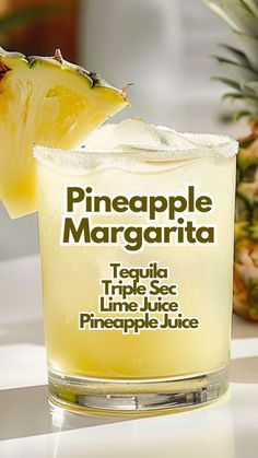 a pineapple margarita is garnished with a slice of pineapple on the rim