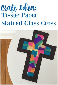 a cross made out of tissue paper sitting on top of a table with text overlay that reads craft idea tissue paper stained glass cross