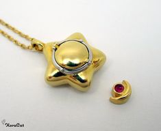 This is a tiny miniature Star Locket necklace pendant inspired by the Sailor Moon series. These are crafted from brass and plated with gold. Each Star Locket pendant opens with a hinged lid, and comes with a 50cm length adjustable gold plated brass chain. There is a removable moon and gem charm inside, attached to the locket centre with magnets. You could also fill this locket with your own small charms, or special objects. Star Locket Size: 18mm Moon and Gem Charm Size: 6mm (H) x 5mm (W) Locket Sailor Moon Star Locket, Sailor Moon Jewelry, Star Locket, Sailor Moon Stars, Locket Pendant Necklace, The Sailor, Magical Jewelry, Dope Jewelry, Small Charms