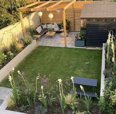 a small backyard with grass and flowers on the ground