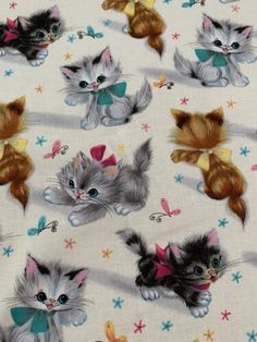 small kittens and butterflies on white cotton fabric with multicolored stars in the background