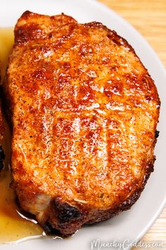 two pieces of meat sitting on top of a white plate