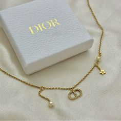 Dior Revolution Necklace In Excellent Condition. 17” Inches In Length With A 1.5” Extender Material: Gold-Finish Metal With A White Resin Pearl And Silver-Tone Crystals This Necklace Is 100% Authentic. I Purchased It At The Dior Boutique In Ala Moana Honolulu. Comes With The Original Box, Dustbag Bag, But I No Longer Have The Receipt. Please Let Me Know If You Have Any Questions. Thank You! Elegant White Jewelry With Logo Charm, Elegant White Necklace With Logo Charm, Elegant Yellow Gold Necklace With Logo Charm, Dior Revolution Necklace, Dior Necklace Pearl, Dior Neackles, Gold Dior Jewelry, Dior Necklace Gold, Vintage Christian Dior Necklace