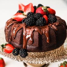 a cake with chocolate frosting and fresh berries on top