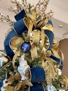 a christmas tree with blue and gold decorations