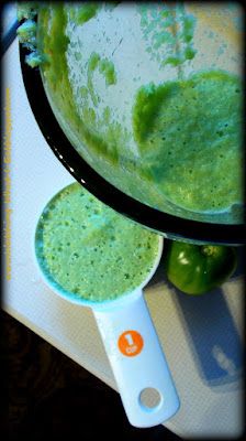 green liquid in a bowl next to an orange on a cutting board