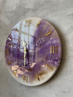 a clock that is on the wall with roman numerals and purple marbled paint