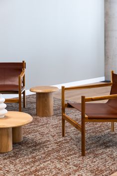 three chairs and two tables in a room with carpeted flooring on the ground