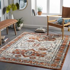 an orange and white rug in a living room with two chairs, a bench and potted plants