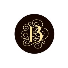 a black and gold monogrammed circle with the letter b in it's center