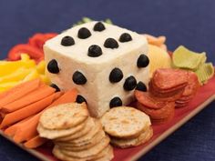 a red plate topped with cheese and crackers