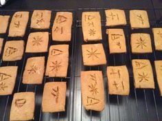 some cookies with writing on them sitting on a cooling rack in the oven, ready to be baked