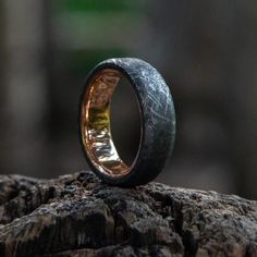 a wooden ring sitting on top of a rock