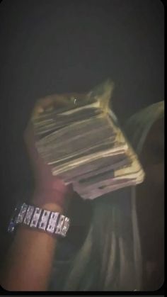 a person holding up a stack of papers