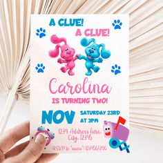 a hand holding up a card with cartoon characters on it and the words carolina is turning two now