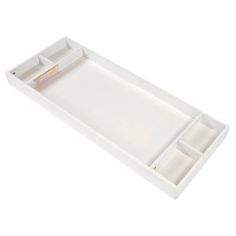 an empty white tray with two compartments on the bottom and one drawer open to show items inside