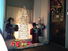 christmas decorations are displayed in front of the door